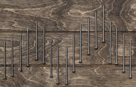 Diagram made of nails on a wooden background