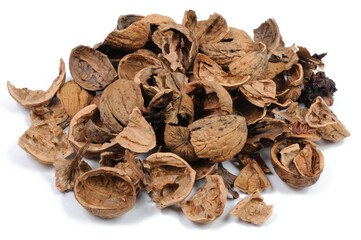 Obraz premium Dried walnut shells on a white background. Close-up.