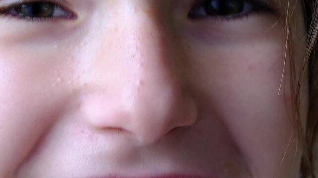 Close-up on girl's teeth, orthodontic plate visible, device for tooth alignment and bite improvement.