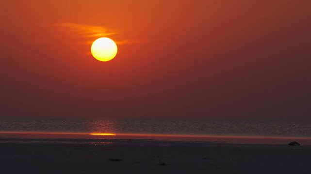 4K Landscape shot of sun above the Rann of Kutch lake during the sunset as seen from Sunset point in Dholavira village in Kutch district, Gujarat, India. Scenic view of sunset in the Rann of Kutch.