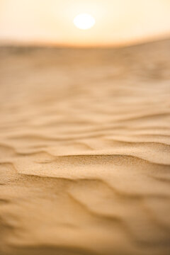 Desert sand texture background with blurred sunset horizon view warm golden light soft natural landscape backdrop