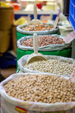 Bags of legumes are put up for sale at a farmers' market.