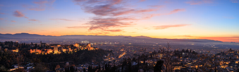 Naklejka premium Panoramic aerial view of Alhambra and cityscape with dramatic sky at sunset, Granada, Spain