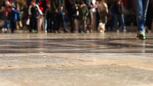 crowded tourists walking on the Plaza de Santa Ana, blurry 