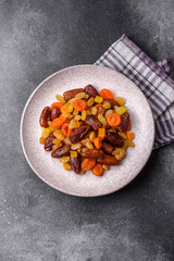 Fototapeta premium Dried apricots, raisins, and candied fruits as ingredients for baked goods and sweets. Dried fruits