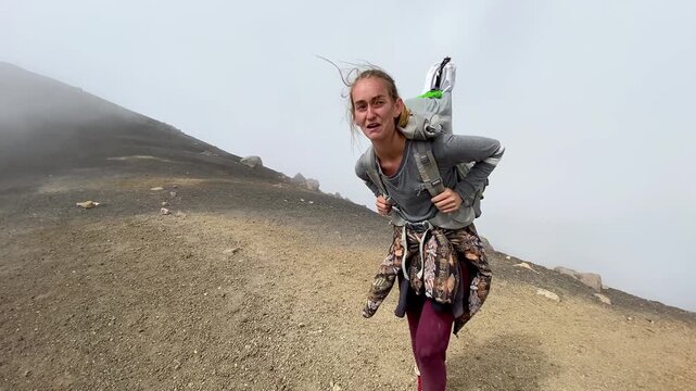 Woman Reaches Summit Hiking Mountain