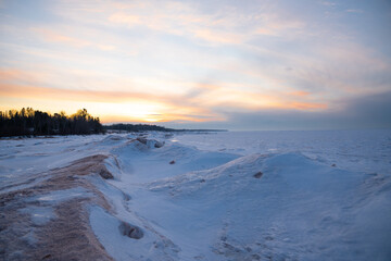 Winter sunset over Lake Superior completly frozen covered in snow 
