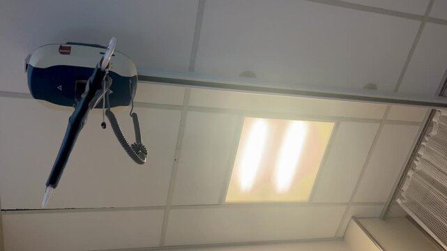 overhead patient lift system mounted on clinical drop ceiling.