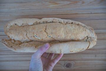 Hand Holding Fresh Homemade White Bread Loaf - Rustic Bakery Concept