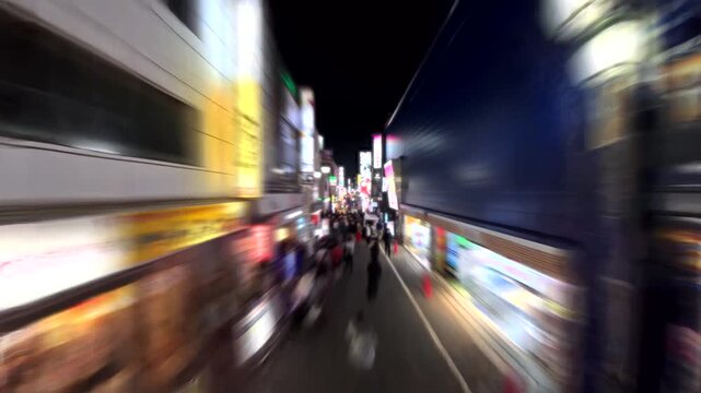 SHINJUKU, TOKYO, JAPAN - FEB 2026 : Blurred aerial time lapse shot of Kabukicho area. Biggest entertainment, red light district in Japan. Japanese urban city nightlife concept video.