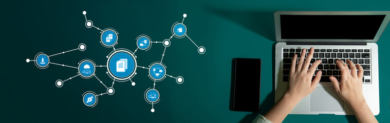 A creative workspace featuring hands typing on a laptop alongside digital icons symbolizing...