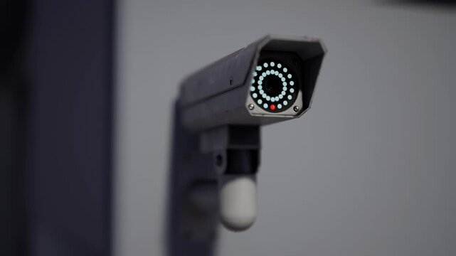 Modern Outdoor Cctv Security Camera Mounted On Building Wall With Blurred City Background