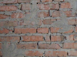 Old red brick wall texture with rough cement mortar