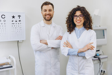 Ophthalmologist team standing in clinic, examining vision and providing eye care services with a...