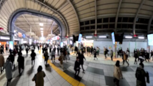 TOKYO, JAPAN - FEB 2026 : Blurred view of crowd of people walking at the busy station in night time rush hour. Many commuters going home. Japanese business people, job and lifestyle concept.
