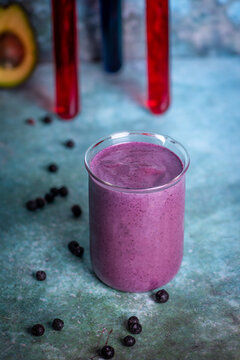 Delicious purple smoothie with fresh blueberries on rustic table