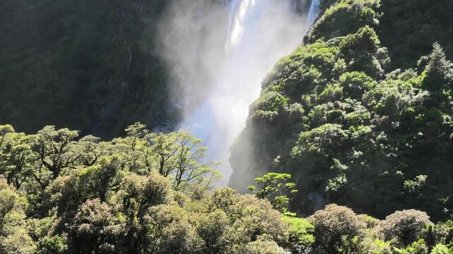 Spectacular Lady Bowen Falls in Milford Sound surrounded by tropical jungle trees, Fiordland national park, South Island, New Zealand