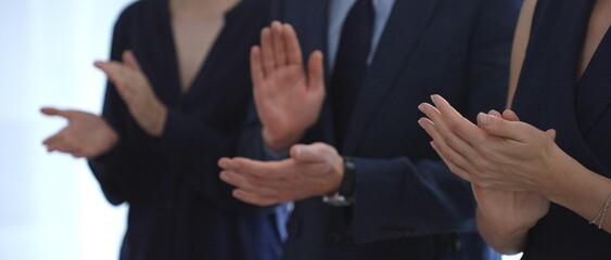 Businesspeople applauding, showing appreciation and celebrating success during a corporate event,...