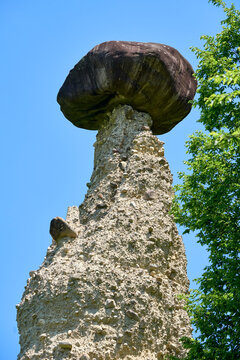 Close-up of Zone Earth Pyramid with large capstone rock, Piramidi di Zone near Lake Iseo, Lombardy, Italy
