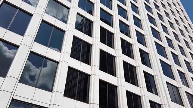 Modern building facade with reflective windows and white panels