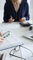 Two professional chartered accountants reviewing financial reports and analyzing data using a...