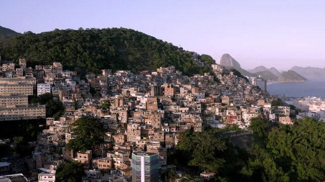 Aerial, panoramic footage of a favela situated between Ipanema and Copacabana in Rio de Janeiro.