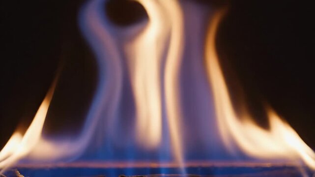 Natural gas flames burning and flickering on dark background for energy and heating content