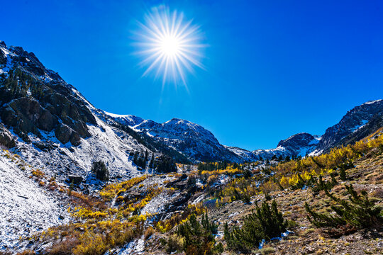 Snow Covered Mountains with Sunburst, sunstar in sky