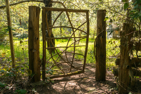 Canada, BC, Denman Island.  Rustic garden gate, left partially open.