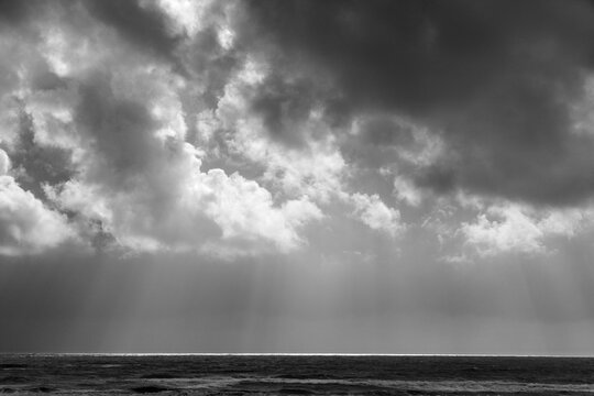 USA, WA, Olympic Peninsula, South Beach.  Light striking the pacific ocean on the horizon, on a stormy day.