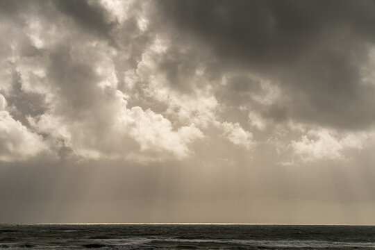 USA, WA, Olympic Peninsula, South Beach.  Light striking the pacific ocean on the horizon, on a stormy day.