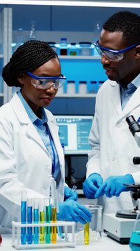 Scientists conduct experiments in a laboratory with test tubes and equipment