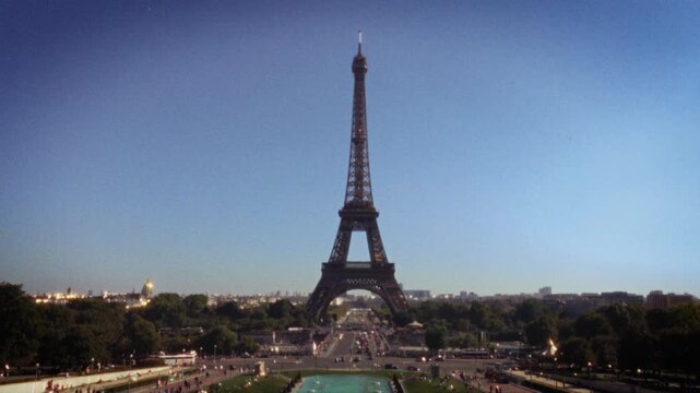 Focuses on eiffel tower, tourism, retro, handheld, blurry, travel, france, paris, film, vintage. Concepts include eiffel tower, tourism, retro, handheld, blurry, and travel. Additional themes: france,