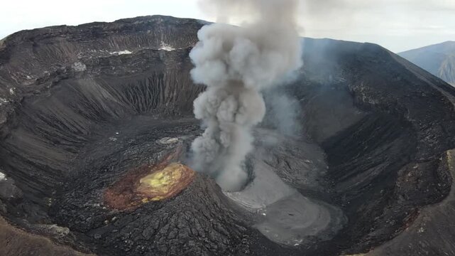 Volcanic eruption with smoke and lava in dark rugged landscape with dramatic cloudy lighting for geology