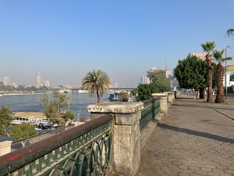 CAIRO, EGYPT - NOVEMBER 7, 2025: Nile riverside wall with city buildings and skyline in the background along the riverbank in central Cairo Egypt
