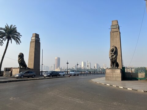 CAIRO, EGYPT - NOVEMBER 7, 2025: Entrance of Qasr El Nil Bridge with iconic lion statues overlooking the Nile River in central Cairo under clear daylight