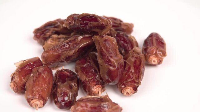 close up of premium dried dates isolated on white. Perfect for Ramadan, healthy snacking, and Middle Eastern food themes