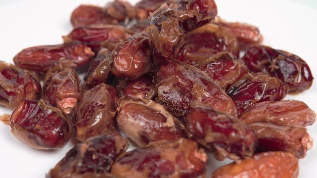 close up of premium dried dates isolated on white. Perfect for Ramadan, healthy snacking, and Middle Eastern food themes