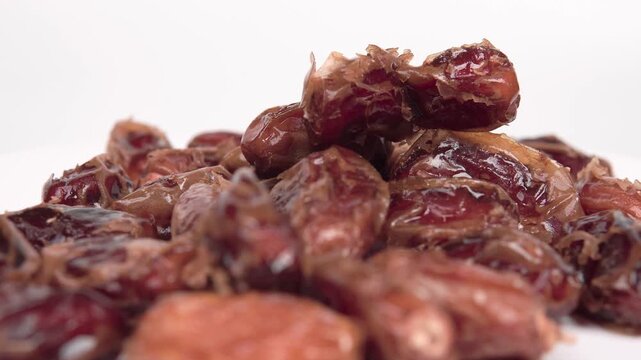 close up of premium dried dates isolated on white. Perfect for Ramadan, healthy snacking, and Middle Eastern food themes