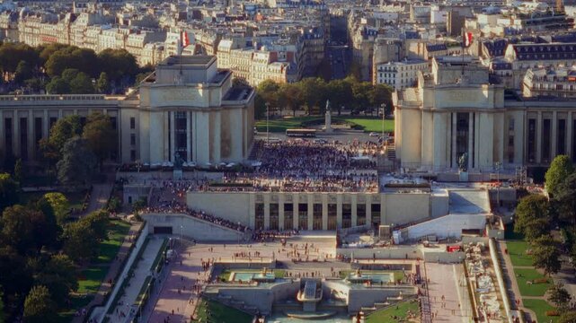 Parisian tourism and cultural heritage Aerial view of the Trocadero Gardens and Chaillot Palace in Paris France with crowds of people filmed in a blurry handheld retro Super 8 film style travel docume