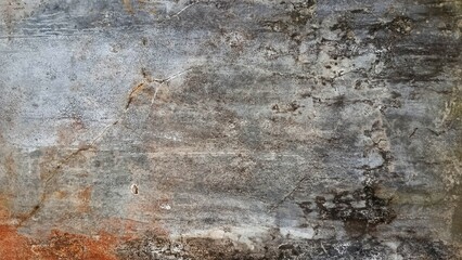 Obraz premium The old concrete walls are gray with fine cracks, black stains, and brownish patc