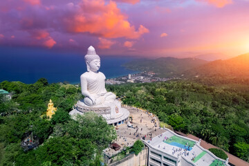 Aerial top landscape scenery sunset purple orange clouds evening sky and blue ocean behind Phuket white big Buddha.