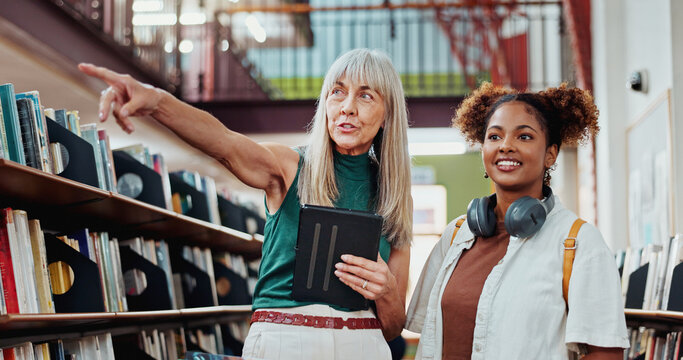 Women, student and help at library with search for books with tablet, point and happy at college campus. People, librarian and girl with tech, application or scholarship with education at university