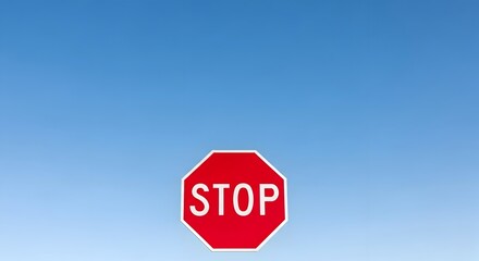 Obraz premium Stop Sign on Blue Sky