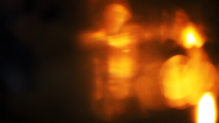 Abstract golden lens flare with warm glowing bokeh on dark background © Farhan