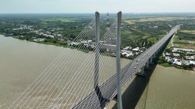 Cao Lanh City, Dong Thap, Southwest Vietnam &ndash; 4K aerial drone footage of cable-stayed bridge crossing the Mekong River with rural houses, fruit farms in the delta landscape, transportation and traffic