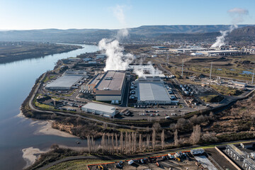 Aerial drone picture of a large data center campus with cooling steam, electrical substation along the Columbia River in The Dalles, Oregon, USA. Power demand for cloud computing AI infrastructure © Hrach