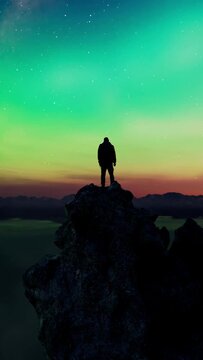 Adventurer Standing on a Mountain Peak Under a Breathtaking Aurora Borealis Sky