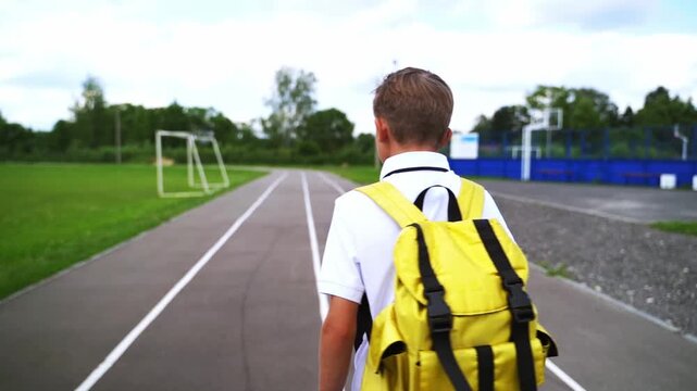 A first grader with a backpack goes to school