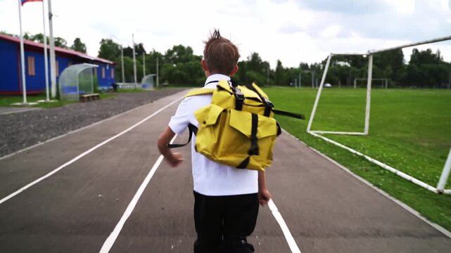 A first grader with a backpack goes to school